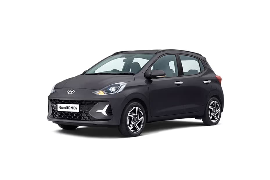 Hyundai Grand i10 Nios 1.2 Era Hatchback Petrol car front three-quarter view India 2026 price mileage safety specs side by side car comparison vs Maruti Suzuki Swift AiCarAdvisor